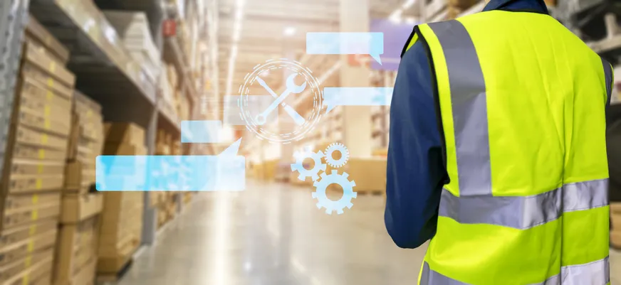 Problem-solving while working in engineering, a man in an engineer's shirt turns around in a warehouse. Problem-solving while working in engineering, a man in an engineer's shirt turns around in a warehouse.