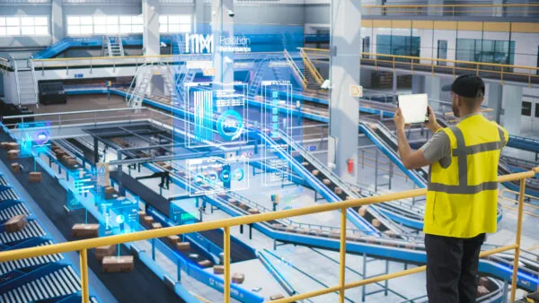 Male in a High Visibility Vest Using Tablet with Augmented Reality App. Worker Monitoring Efficiency in a Logistics Center with Automated Belt Conveyors for Sorting Retail Orders. VFX Visualization Male in a High Visibility Vest Using Tablet with Augmented Reality App. Worker Monitoring Efficiency in a Logistics Center with Automated Belt Conveyors for Sorting Retail Orders. VFX Visualization